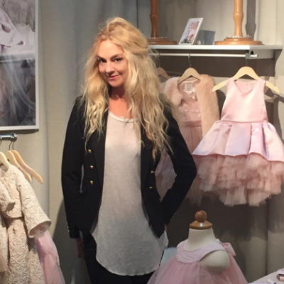 Fashion Designer Heidi Schwarck stands among her creations