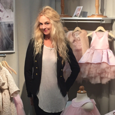Fashion Designer Heidi Schwarck stands among her creations