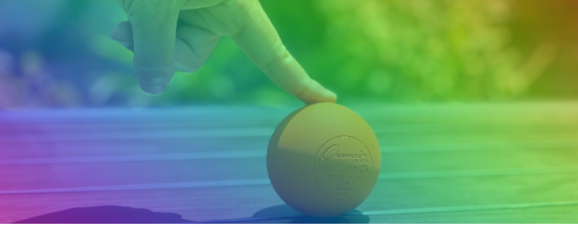 Rainbow colors of finger touching down on an orange ball