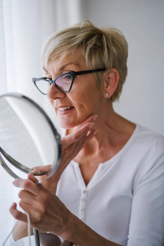 Elderly Woman at home having skin care routine