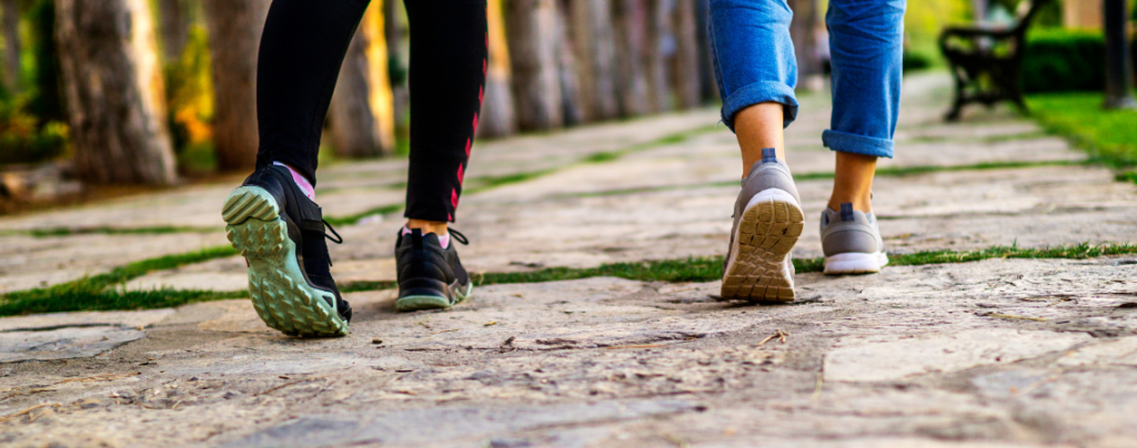 Close up of womens shoes walking along a stone path