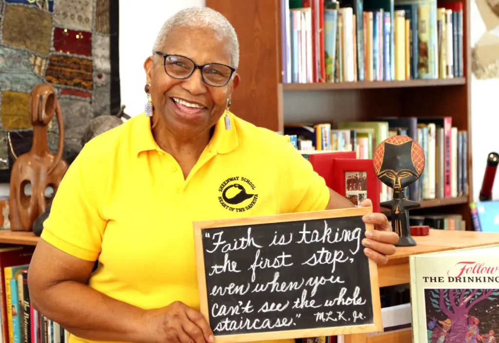 Dolores Sheen holds quote by MLK