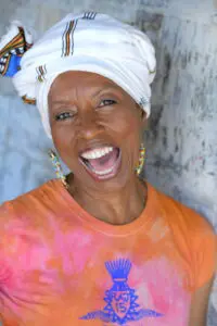 Black woman with scarf smiles