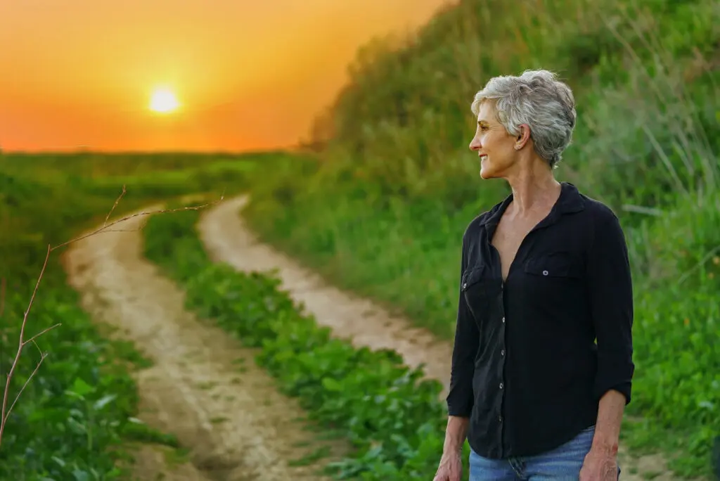 woman with grey hair sees the sunset