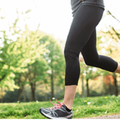Woman running along path
