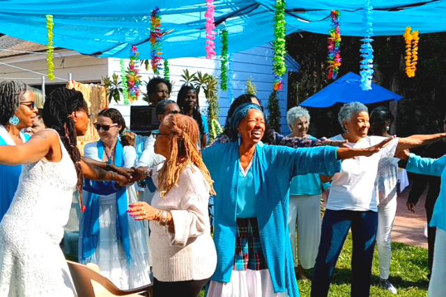 Community of women dancing and laughing