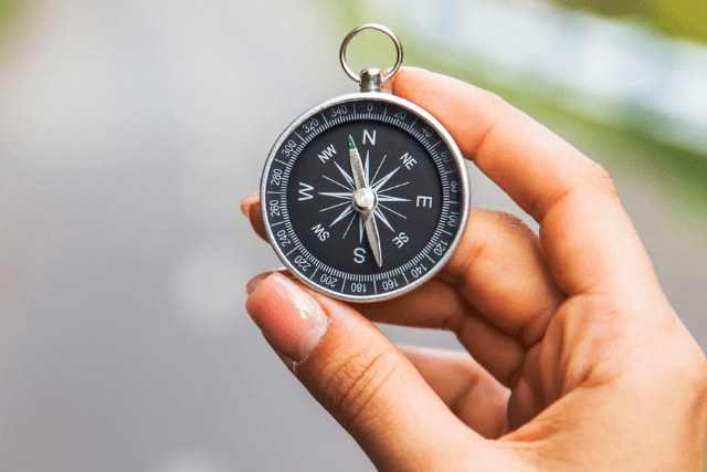 hand holding compass