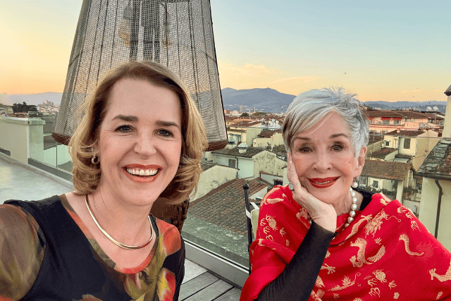 Empowered women enjoying rooftop view, vibrant cityscape, and health at Intentfully Fit.